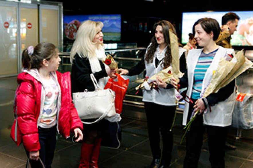 Female passengers get flowers and postcards at Zvartnots Airport 