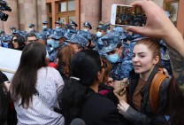 Police officers apprehend women protesters outside Armenia’s government building