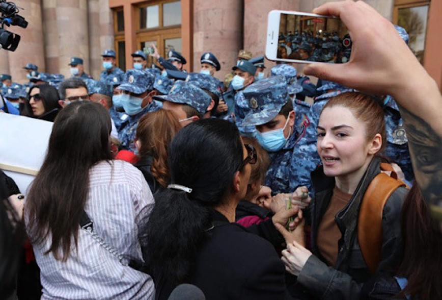 Police officers apprehend women protesters outside Armenia’s government building